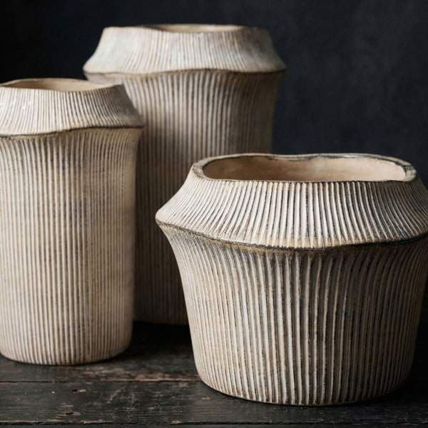 Frollo Ribbed Cement Vase in Natural, styled in a room