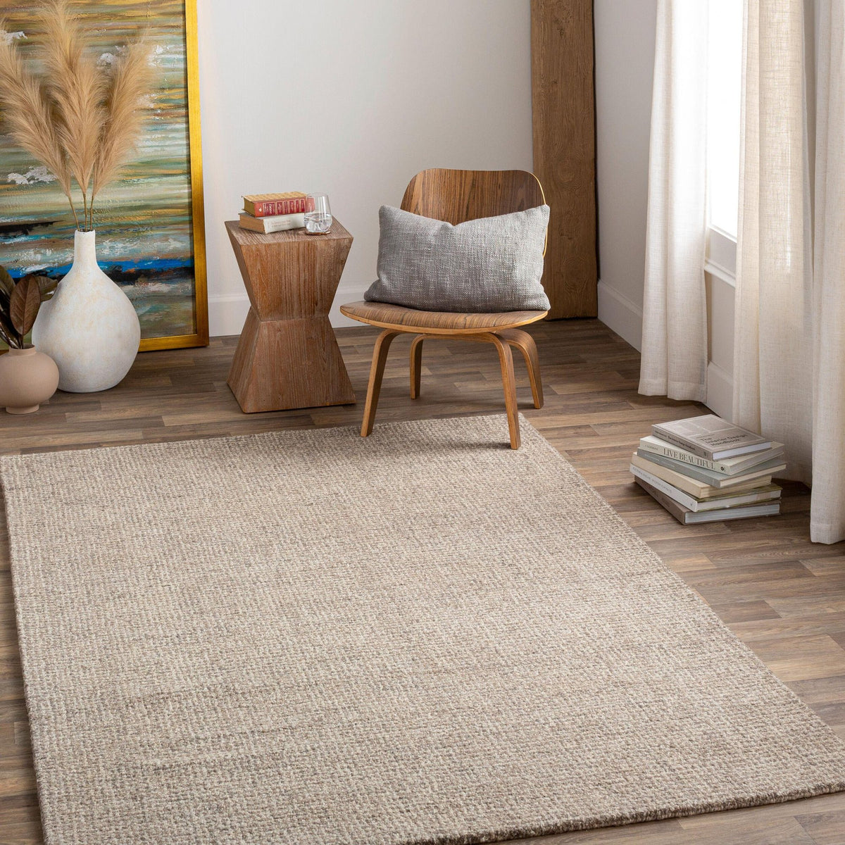 Reading corner with a neutral textured rug and a wood chair